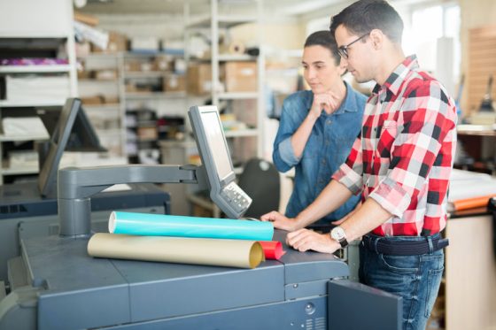 coworking man woman using printer